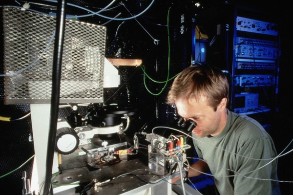 Researcher using patch clamping apparatus for ion