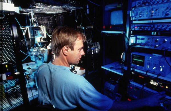 Researcher using patch clamping apparatus for ion