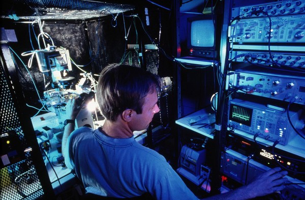 Researcher using patch clamping apparatus for ion