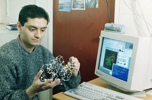 view Researcher with 3-D model of protein