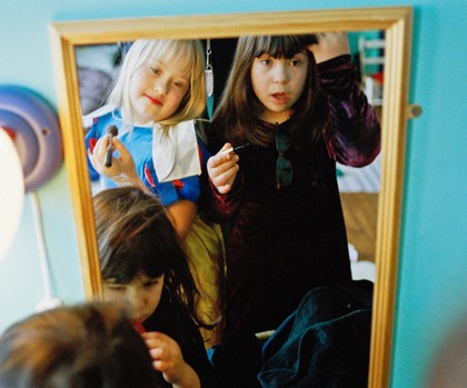 Young girl with Down’s syndrome playing with friends