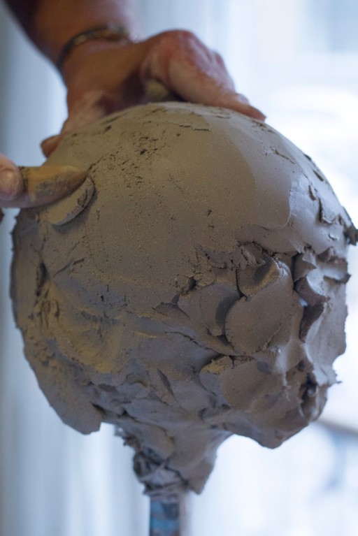 Human head sculpted in clay, early stage in process