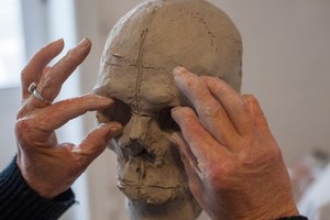 view Human head sculpted in clay, forming the eye sockets