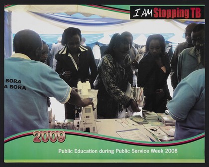 Africans gathering information leaflets from a table: tuberculosis prevention in Kenya. Lithograph by Ministry of Public Health and Sanitation, 2009.