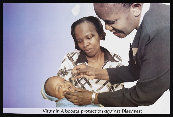 A mother holds a baby who receives vitamin A from a health worker in Kenya. Colour lithograph, ca. 2000.