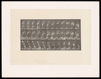 A clothed woman carries a basket and jar then places them on the ground. Collotype after Eadweard Muybridge, 1887.