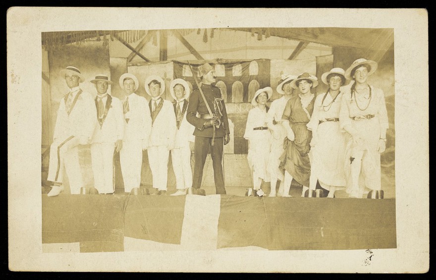 Eleven sailors performing in a play on the Ark Royal. Photographic postcard, 191-.