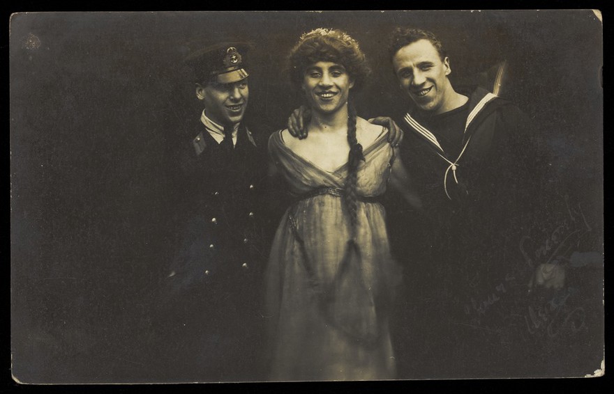 Three sailors with arms round each other. Photographic postcard, 1917.