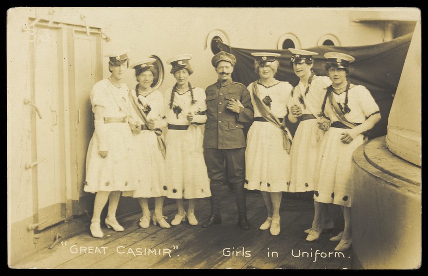 Seven sailors standing together on deck. Photographic postcard, 1918.