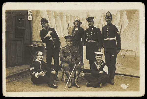 Characters on the set of a play. Photographic postcard. 191-.