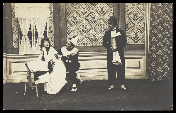 Three men performing a scene from a play. Photographic postcard. 191-.