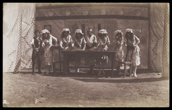 British servicemen in drag acting out a cooking class. Photograph, 191-.