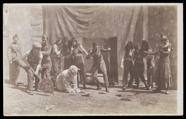 British airforce servicemen performing a sketch, striking an animated pose. Photograph, 1918.