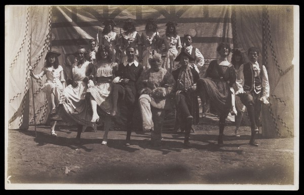 British servicemen dancing in a line, some are in drag. Photograph, ca. 1918.