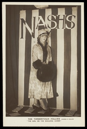 A soldier in drag modelling for "The Timbertown Follies" at a prisoner of war camp in Groningen. Photographic postcard, 191-.