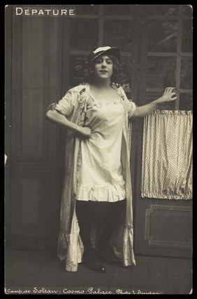 A prisoner of war dressed in drag. Photographic postcard by L. Soudan, 191-.