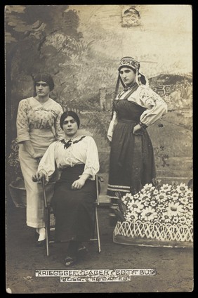 Russian prisoners of war performing a show at a prisoner of war camp in Cottbus, with flower-bed prop. Photographic postcard, 191-.