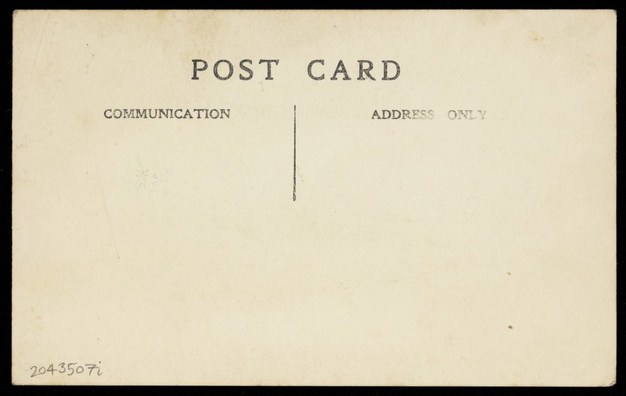 A sailor in drag, wearing a long coat and hat, sits reading in a garden. Photographic postcard, ca. 1920.