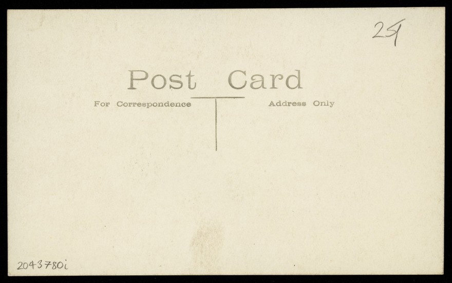 Actors, one in drag, performing "The man From Toronto", pose on set for a group portrait. Photographic postcard, 192-.