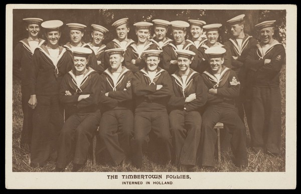 British prisoners of war posing for "The Timbertown Follies", at a prisoner of war camp in Groningen. Photographic postcard, 191-.