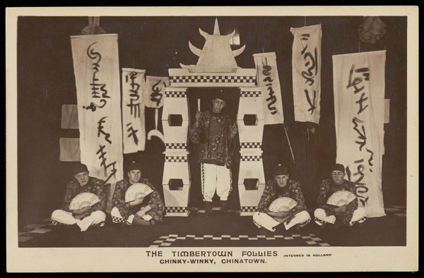 British prisoners of war, posing for "The Timbertown Follies", at a prisoner of war camp in Groningen. Photographic postcard, 191-.