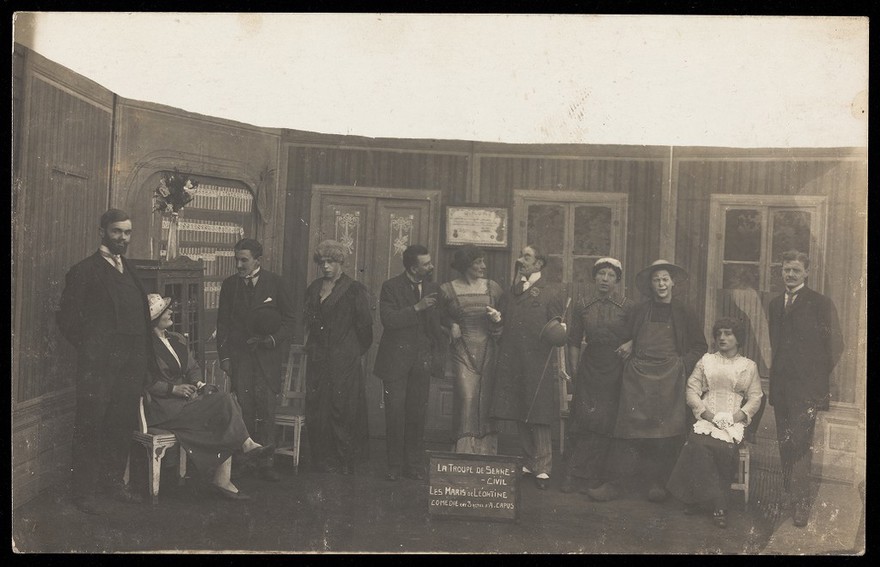French prisoners of war, some in drag, in a performance of "Les maris de Léontine" at Sennelager prisoner of war camp in Germany. Photographic postcard, 1918.