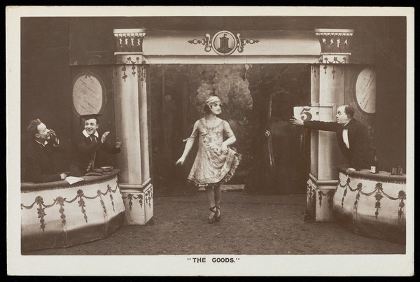 Soldiers, one in drag, performing in the concert party "The Goods". Photographic postcard, 1918.