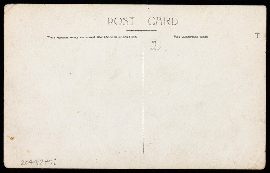 Amateur actors, some in drag, posing on stage for a group portrait. Photographic postcard by E. Pye, 191-.