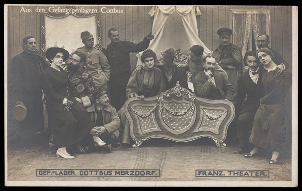 French prisoners of war performing a play at a prisoner of war camp in Cottbus. Photographic postcard by P. Tharan, 1916-1917.