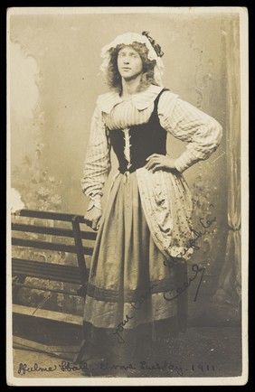 Maitland Cecil Melville Wills posing in a black corset and heavy skirt.