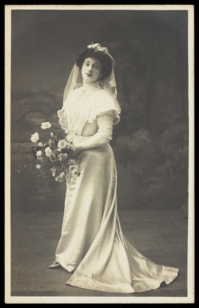 Arthur Grayson, dressed as a bride, for "The Jollity Boys". Photographic postcard, 1909.