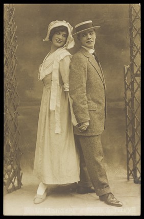 Willie Manders and Frank A. Terry, in character; posing back to back. Photographic postcard, 192-.