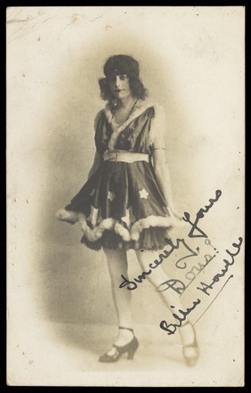 Billie Howell performing in a costume with a fur trim.