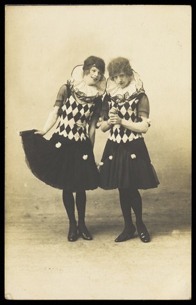 Two actors in drag, performing in character; wearing matching costume. Photograph, 191-.