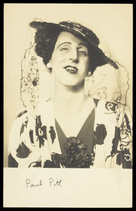 Paul Pitt in drag, posing in flowery garments. Photographic postcard, 194-.