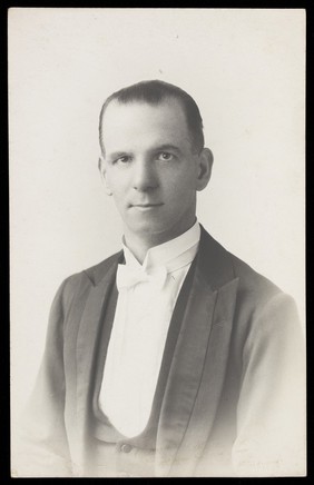 Ralph Mellor, dressed in smart attire. Photographic postcard by L.S. Langfier, 192-.