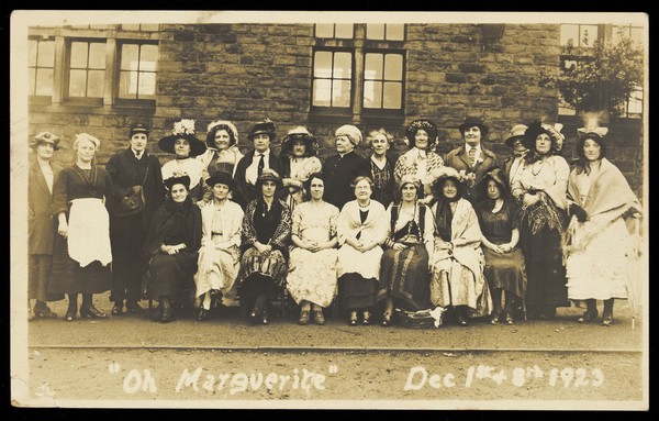 Women in costume pose for a large group portrait on the street; for "Oh Marguerite". Photographic postcard, 1923.