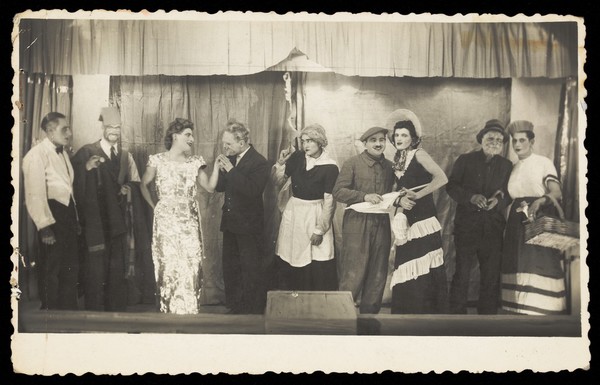 Actors, some in drag, pose at a "French" concert party.