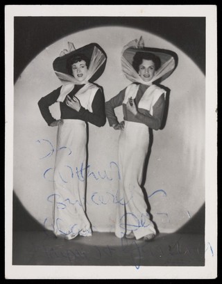 Alan Haynes and Terry Gardener performing in drag in their revue 'Why go to Paris". Photograph, 1950.
