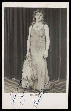 Bert O'Dare in drag, performing on stage. Photographic postcard, 1946.