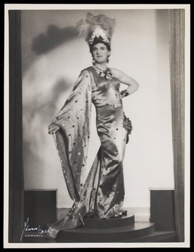 An actor in drag, performing on stage at the Windmill Theatre. Photograph by Mme Yvonne, 194-.