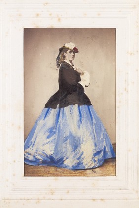 An man in drag posing side-on. Photograph, 1862.