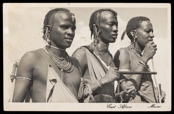 Photograph of three Maasai men in three-quarters profile.