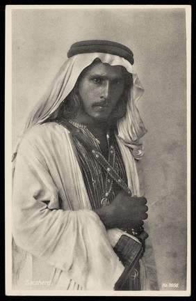 Photograph of a shepherd looking at the viewer, Palestine.