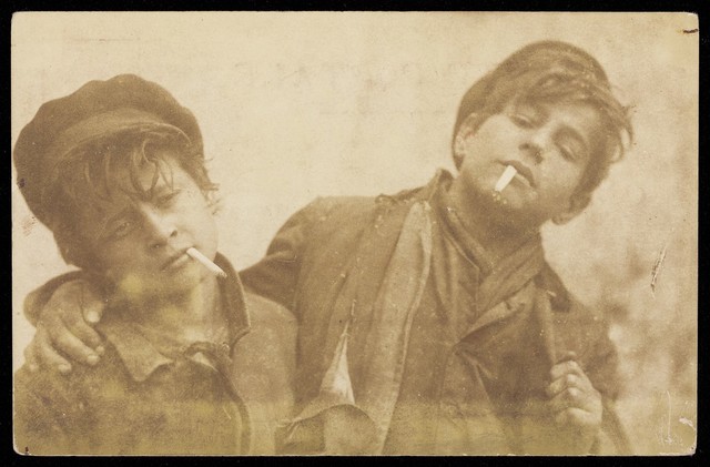 Two boys posing with cigarettes. Photographic postcard by A. Caggiano, 190-.