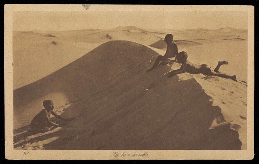 Egypt: three children playing in sand. Process print, 192-.