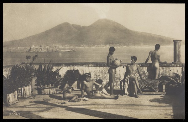 Five naked youths relaxing on a terrace on the bay of Naples. Photographic postcard by W. von Gloeden, 19--.