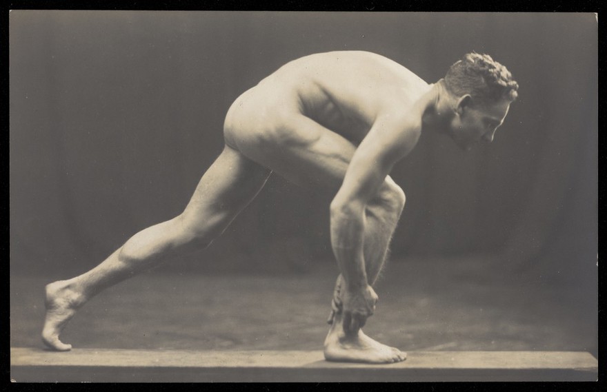 Laurence Woodford in a starting pose for running a race. Photographic postcard, 192-.