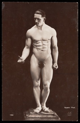 A nude man posing as a classical statue. Photograph by Henry, 192-.