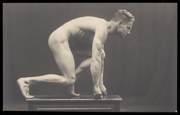 Laurence Woodford in a start pose for running a race. Photographic postcard, 19--.